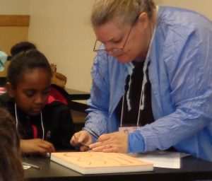 DSC00100_Dr Behm Helping Girl w- Suturing